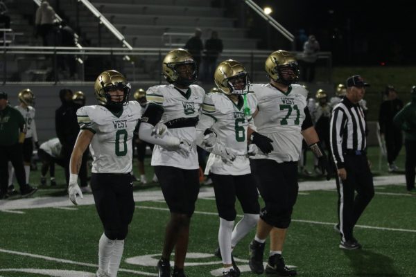 The senior captains of the team approach midfield for their final coin toss. 