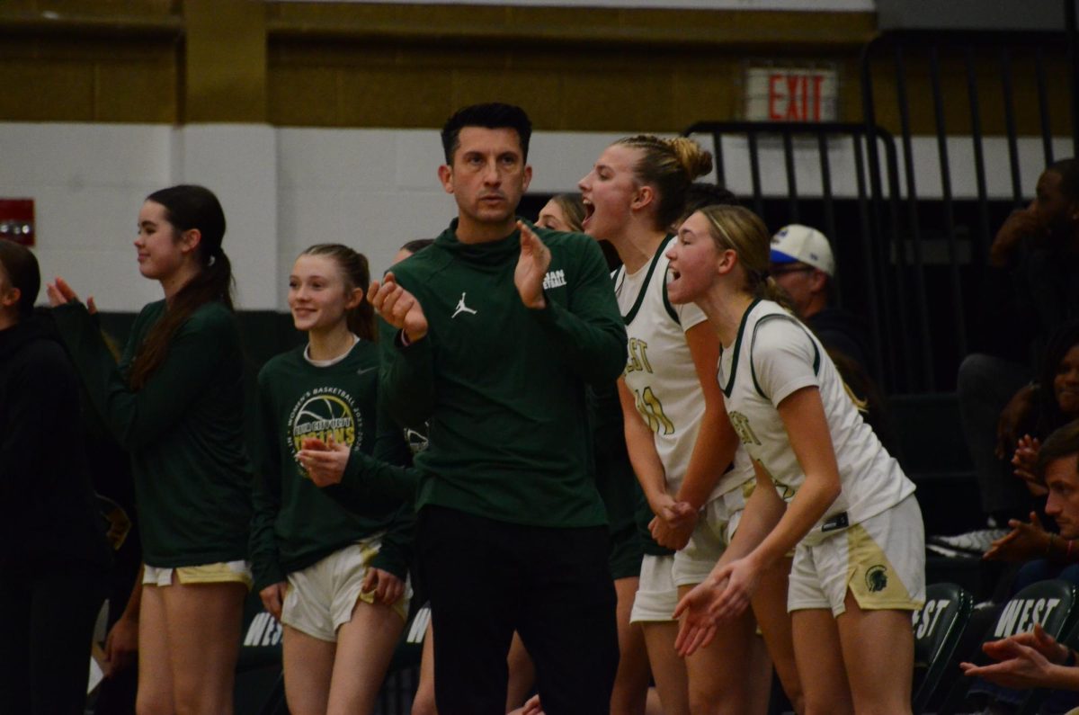 Coach Nate Freese claps his hands in celebration 