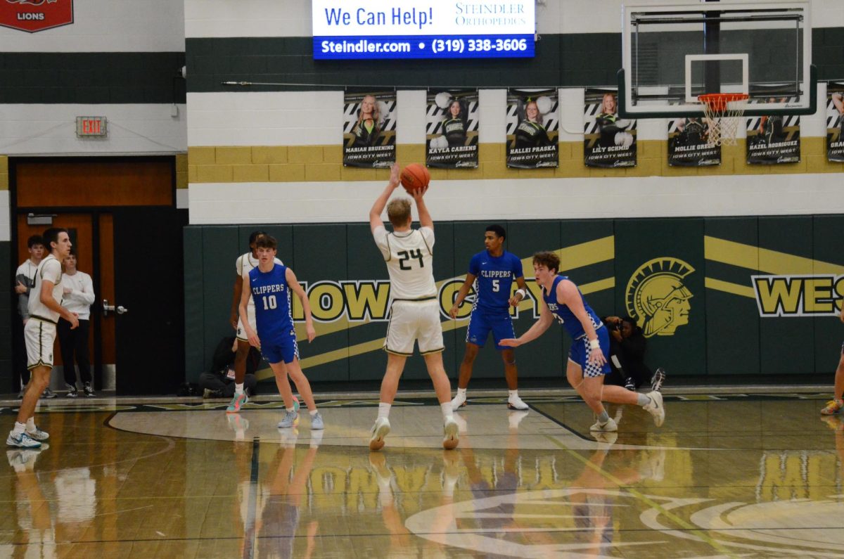 Owen Harms '26 shoots a Three-pointer in a game against Clear Creek-Amana