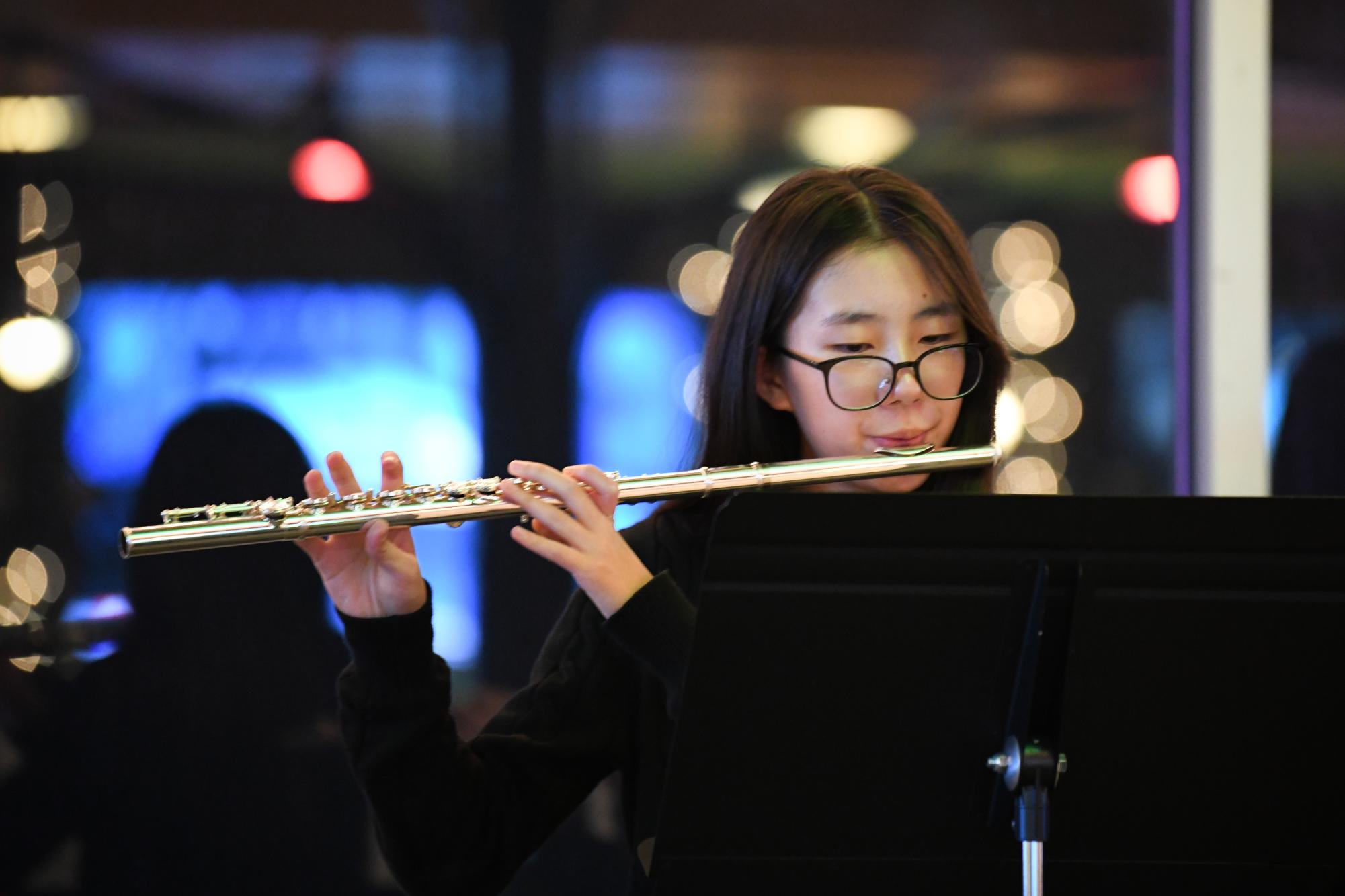Playing in a flute quintet, Youan Lee '29 performs "Simple Gifts." On Dec. 10, the quintet — comprised of freshmen Kate Qian, Eli Gomez, Khloe Zhao, Angela Wang and Lee — performed at Vue Rooftop for Cadenza's Holiday Carols.