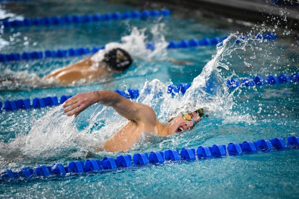 Swimming the 500-yard freestyle, Nikolai Paulson '26 finishes the race. Paulson placed second in the Little Hawk Invite at Mercer Park Aquatic Center Dec. 20 with a time of 5:02.26.