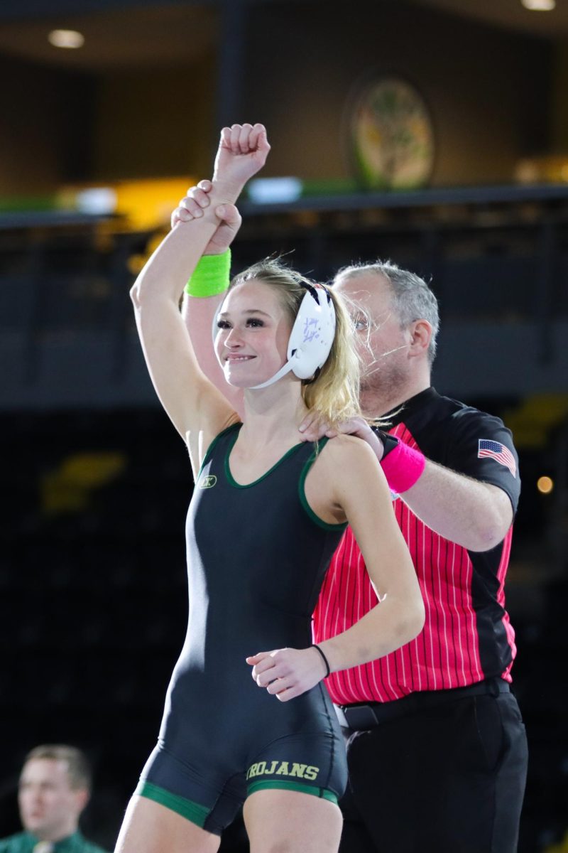 Raising her hand high, Lila Bihun ‘27 accepts City High’s forfeit at 105 pounds. City’s forfeits at 100 and 105 pounds due to not having someone to wrestle the weight gave West a strong start to the dual.