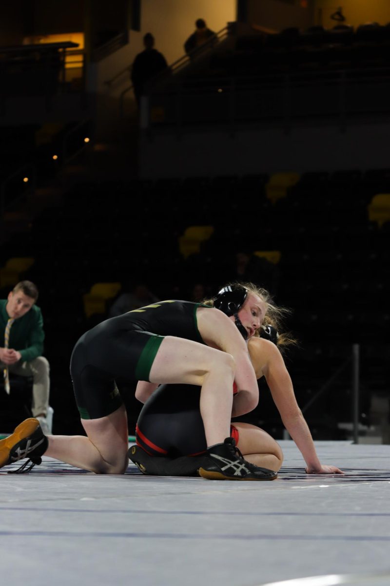 Starting in the top position, Kaylee Hampton ‘28 waits for the referee’s whistle to start out the period. The match ended with 29 points on the board, with Hampton losing 18-11 Dec. 18.