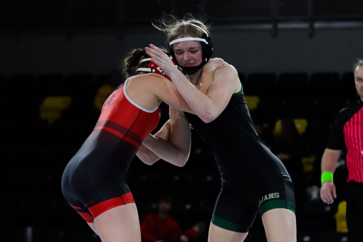 Josie Clark ‘28 pushes back against her opponent from City High Dec. 18. Clark lost by fall in one minute and 28 seconds, putting another six points on the board for City High.