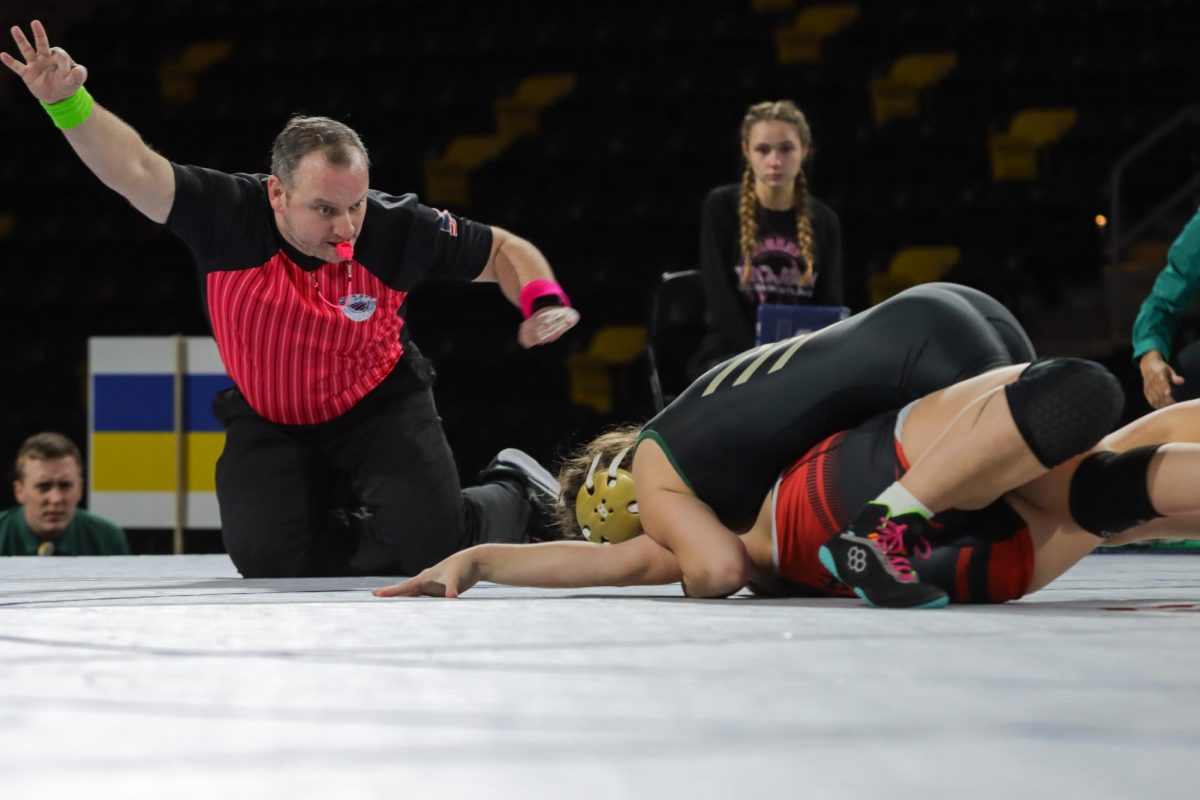 Fighting for the pin, Noah Overholt ‘28 drives her opponent to the mat as the referee announces another three points in her favor. Overholt won her match with a fall in three minutes and 30 seconds after already having 17 points on the board.