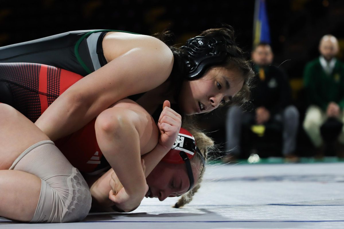 Eva Jara ‘28 wrestles her opponent from City High from the top position Dec. 18. Jara lost her match by fall in a minute and 57 seconds.