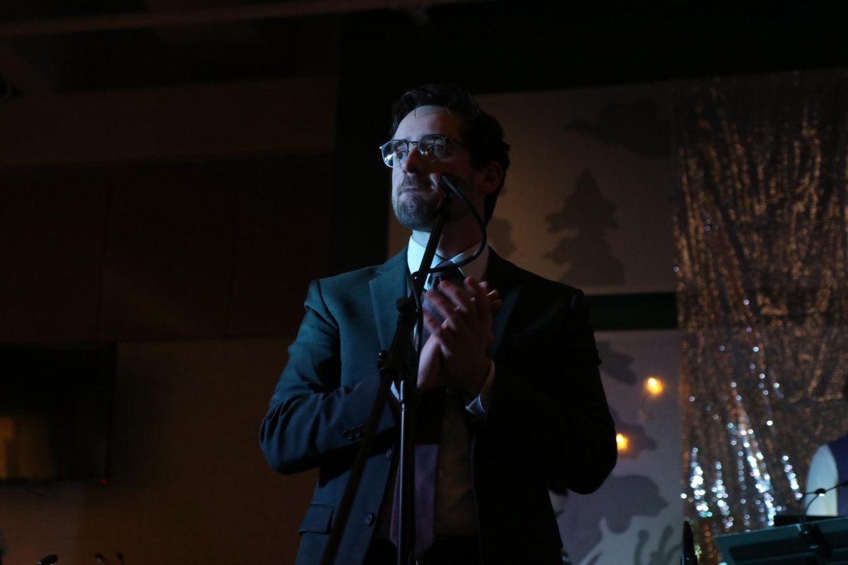 After performing "Alamode," director Ryan Middleton applauds for Jazz Collective. Middleton led both Jazz Collective and Jazz Lab at the annual Jazz Café at West High Dec. 13.