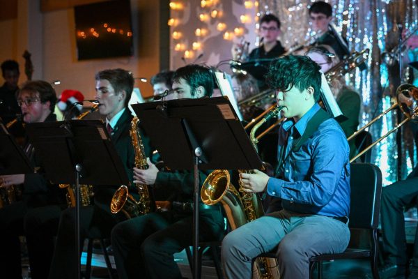 Playing the baritone saxophone, Evan Liu '28 performs "Uptown Swing" with Jazz Ensemble. On Dec. 13 at West High, Jazz Ensemble performed at the annual Jazz Café.