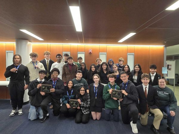 The entire ICW Debate team poses with their awards after winning the sweepstakes trophy. 