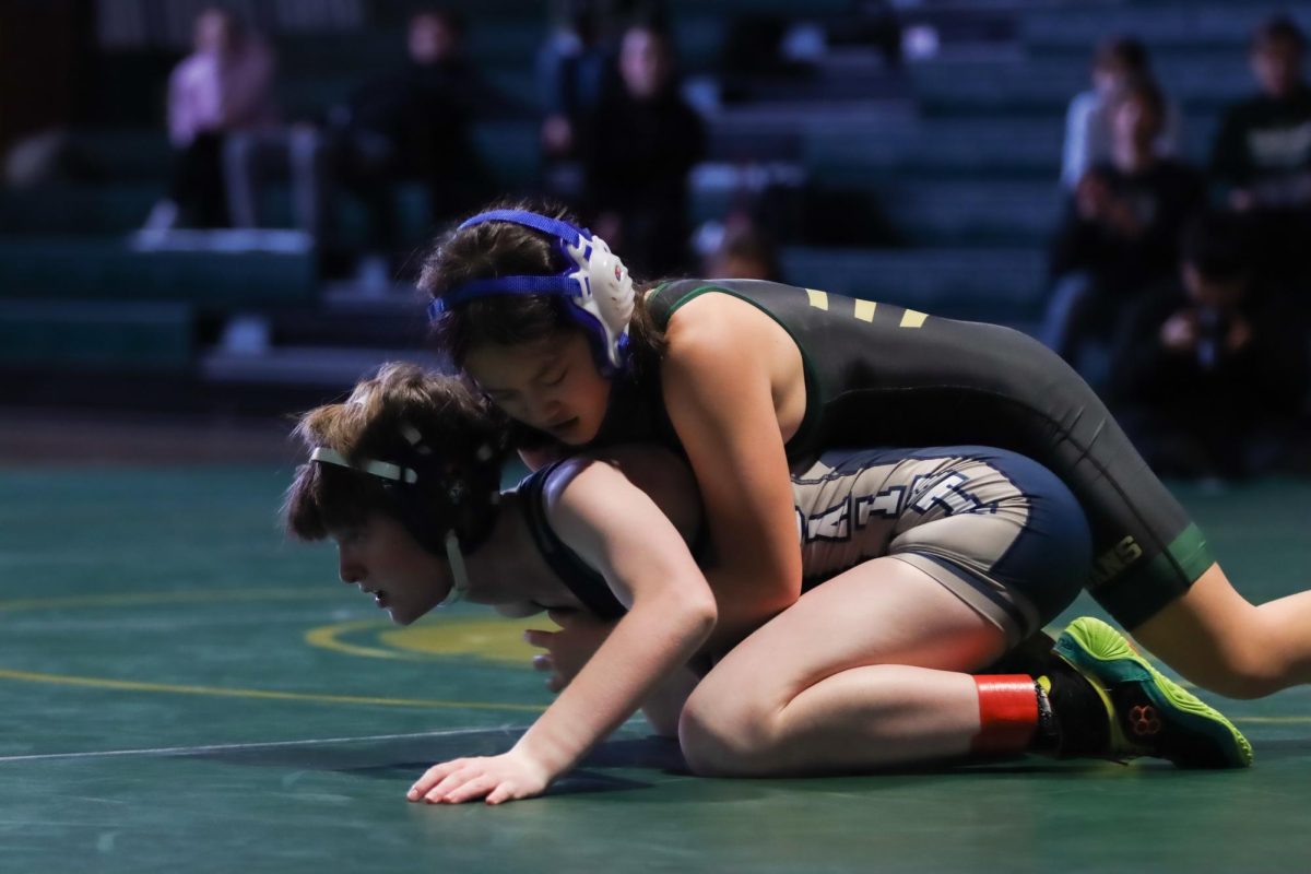 Angela Wang '29 wrestles from the top position during West's match against Xavier Jan. 8. She won her match by fall in two minutes and 16 seconds.