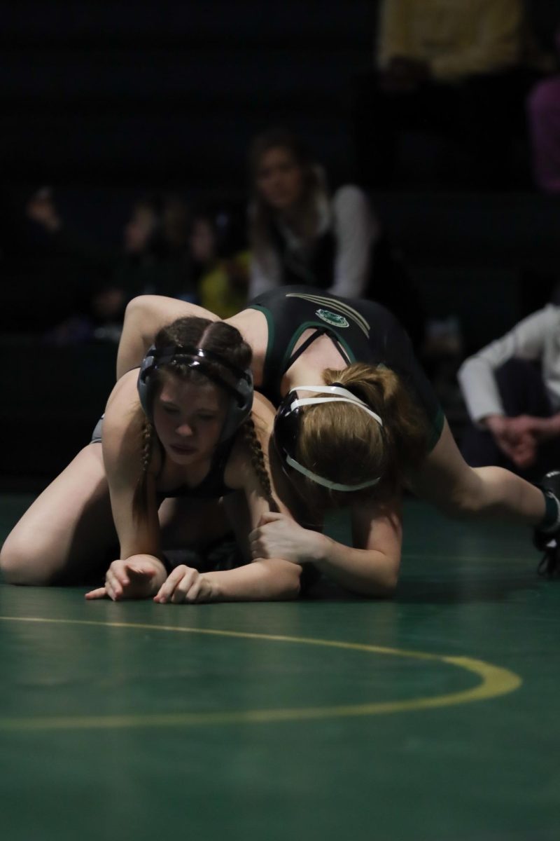 Wrestling from the top position, Josie Clark '28 attempts to break down her opponent. Clark lost her match by fall in five minutes and 10 seconds.