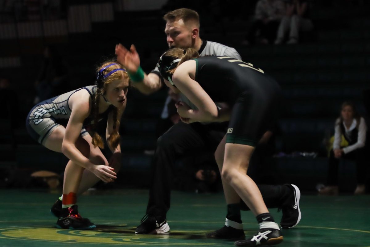 The referee blows his whistle to mark the start of sophomore Micheala Vogel's match. 