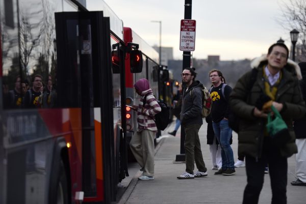 Iowa City residents and University of Iowa students board an Iowa City public bus near the Pentacrest Feb. 9. All fares were removed on public buses after the implentation of the Fare-Free program in August 2023. 