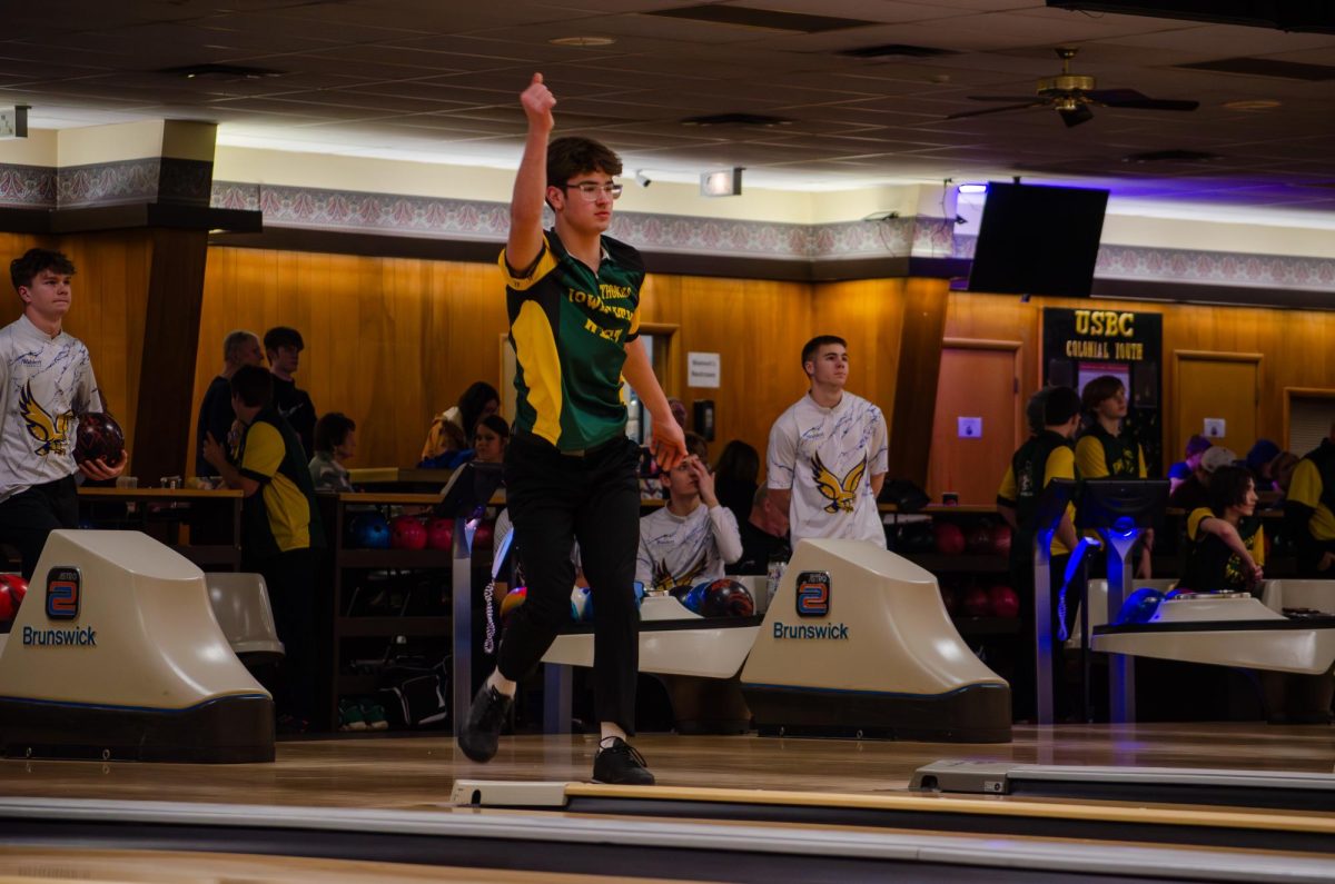 Thomas Butler '26 watches the bowling ball roll down the lane. The West High Boys bowling team competed against Wahlert Catholic on Feb. 6.