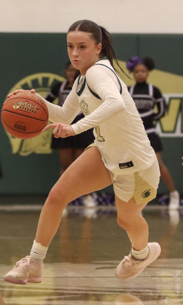 Senior Ava Frese drives up the court to score Feb. 24.