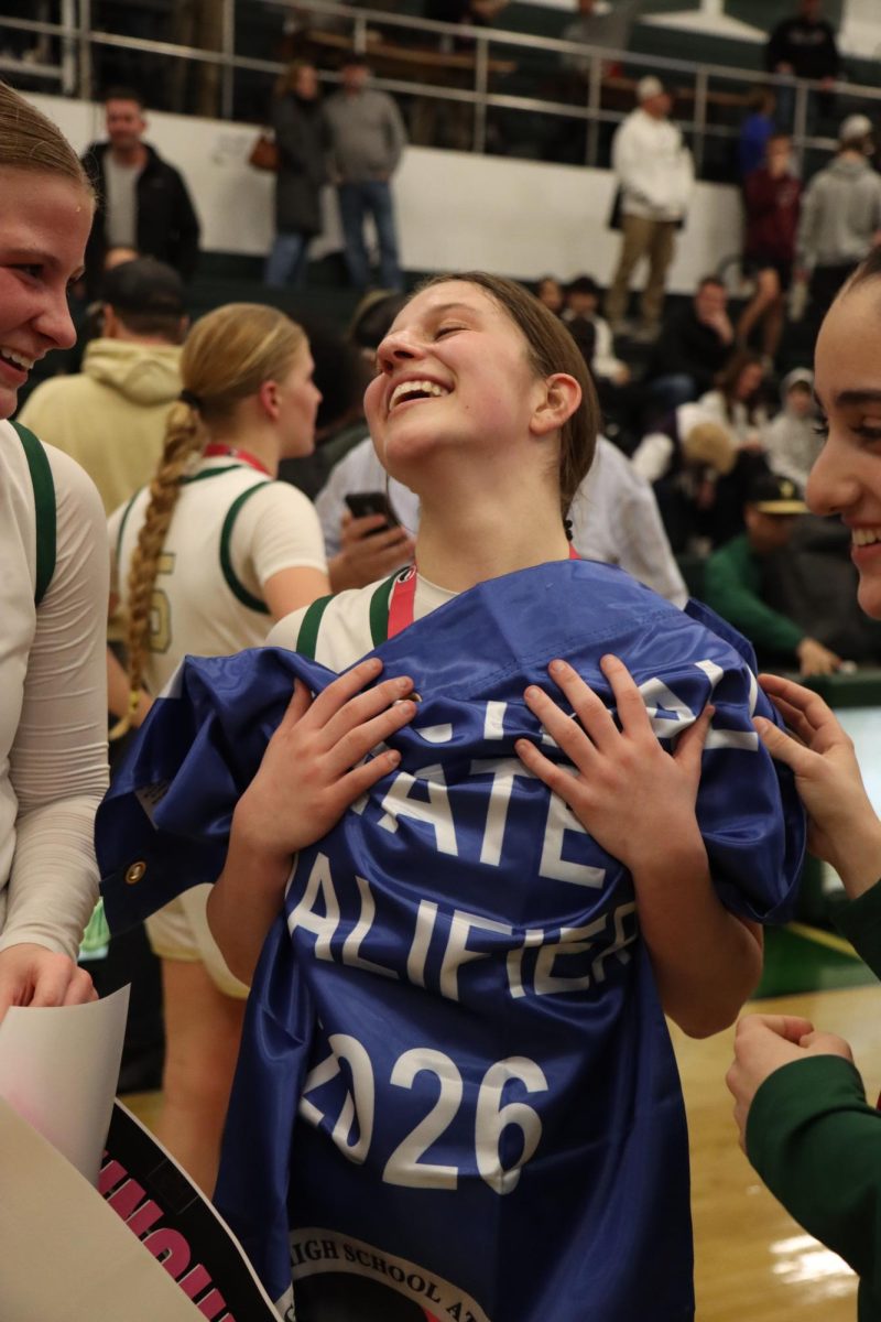 Letting the win sink in, Sasha Baldwin '27 holds the state qualifying banner to her heart. "It's a dream come true. Honestly it's something we have been trying to accomplish since I was a freshman. It still doesn't feel real," Baldwin said.