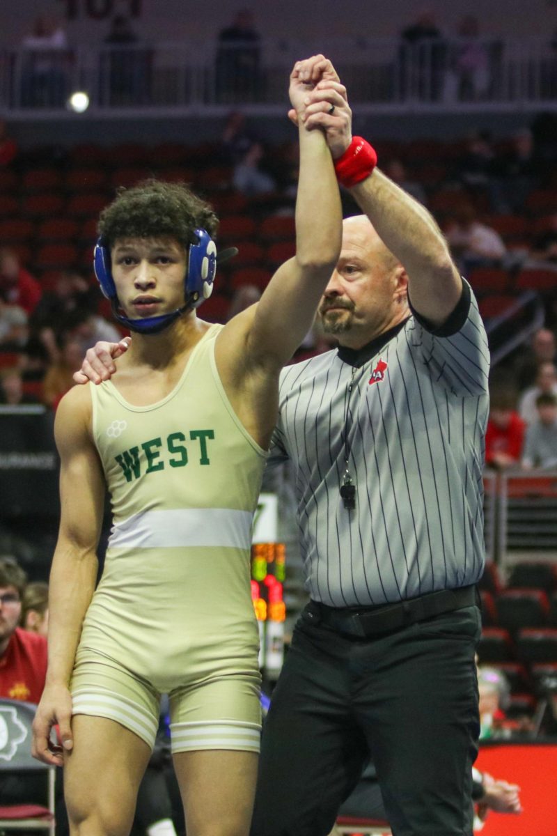 Diego Robertty '29 celebrates his victory to advance to the state finals Feb. 20.