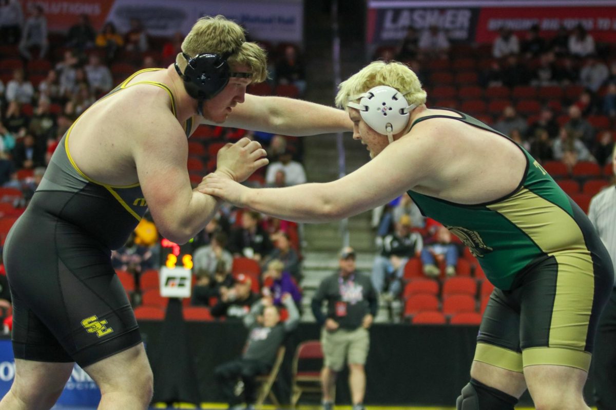 Kaden Stitt '26 grapples with his opponent at the state wrestling tournament.
