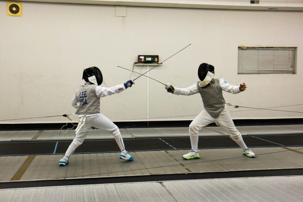Parrying a sword, Lucas Lee '31 fences against an opponent at the Iowa City Fencing Center on Feb. 6.