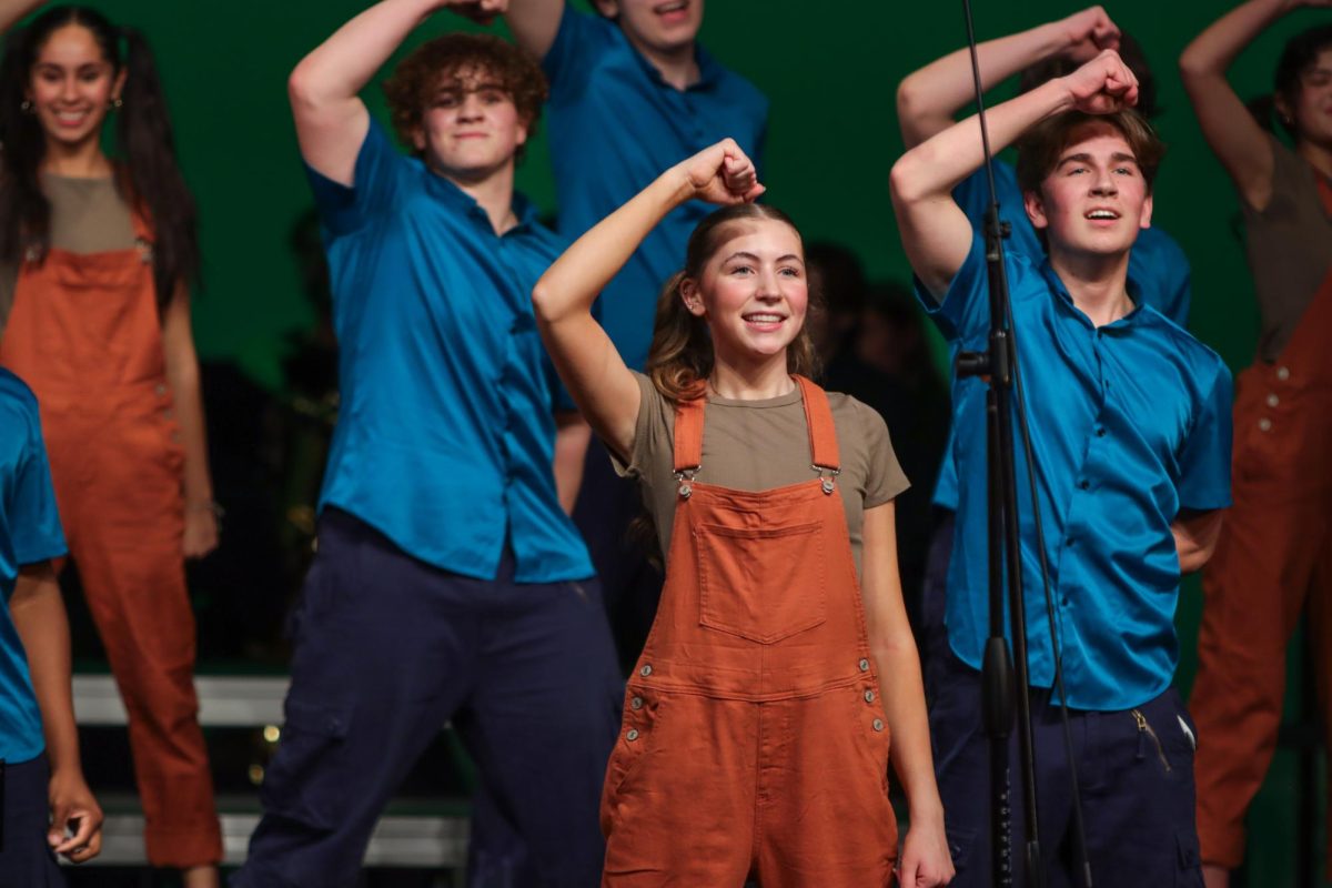 Lily Colleran '28 dances with the music alongside varsity show choir Good Time Company. GTC's theme this year is "Minecraft," featuring songs about the creative spirit.