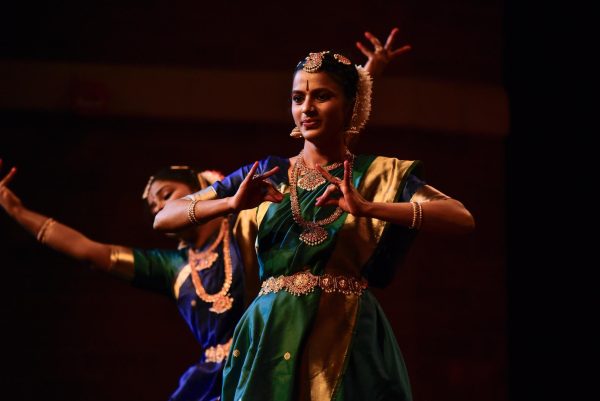 Dancers Amrutha Akula, Keerthana Ramkumar and Thaneesha Puviarasan perform a traditional Bharatanatyam dance, rotating as the plot advances, with two dancers staying in the common resting position. 