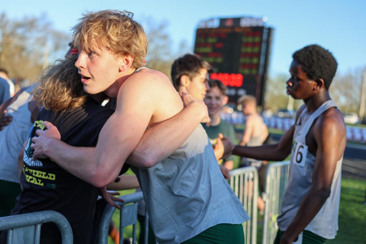 Aiden Nelson ’27 embraces coach Josh Kidman after racing the 400m leg of the distance medley relay at the Forwald Relays April 16. The distance medley quartet of Nelson, Kellen Craig ’26, Neil James ’27 and Dara Olaleye ’27 raced a Drake blue standard time of 3:32.66.
