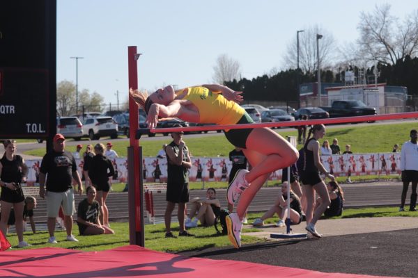 Jumping over the bar, Evelyn Cornish '27 competes in the high jump at Iowa City High School April 16. Cornish jumped 4-11.00, earning a three-way tie for sixth.