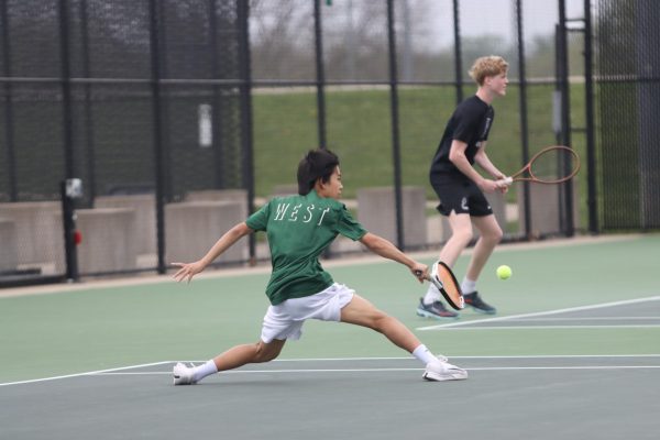 Tommy Gao ’29 hits a backhand slice at the West High tennis courts April 23.
