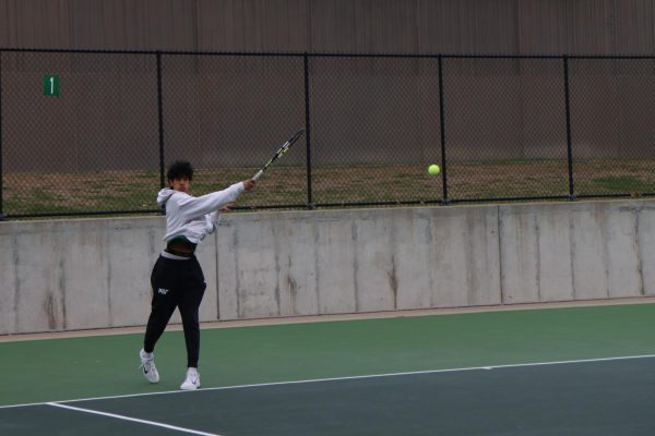 Aryan Harwani ’29 hits a forehand in a rally against Dubuque Hempstead at the West High Courts April 7.
