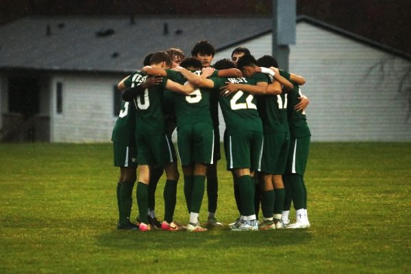 Before the match commences, the Trojan starting lineup circles up to give advice and mentally prepare themselves to play.