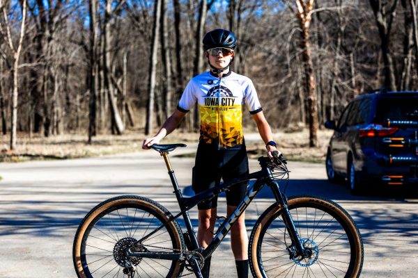 Preparing for the season, Axel Brandsmeier ’29 poses in his Iowa City Mountain Bike Club cycling kit.
