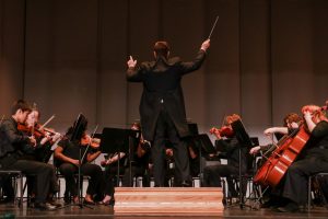 Orchestra Director Jon Welch conducts Philharmonic Strings at the spring concert May 27. The group performed second after Concert Strings.