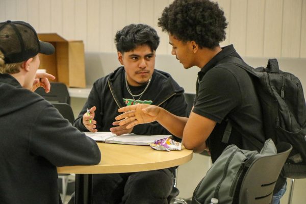 Luis Lopez Riveros '27 discusses with a classmate during the study session in the commons May 7.