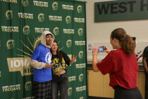 Lydia Evans ’26 captures a photo of seniors Adriana Vargas and Shadi Elsiddig as they pose together in their college decision shirts on Decision Day, May 1.