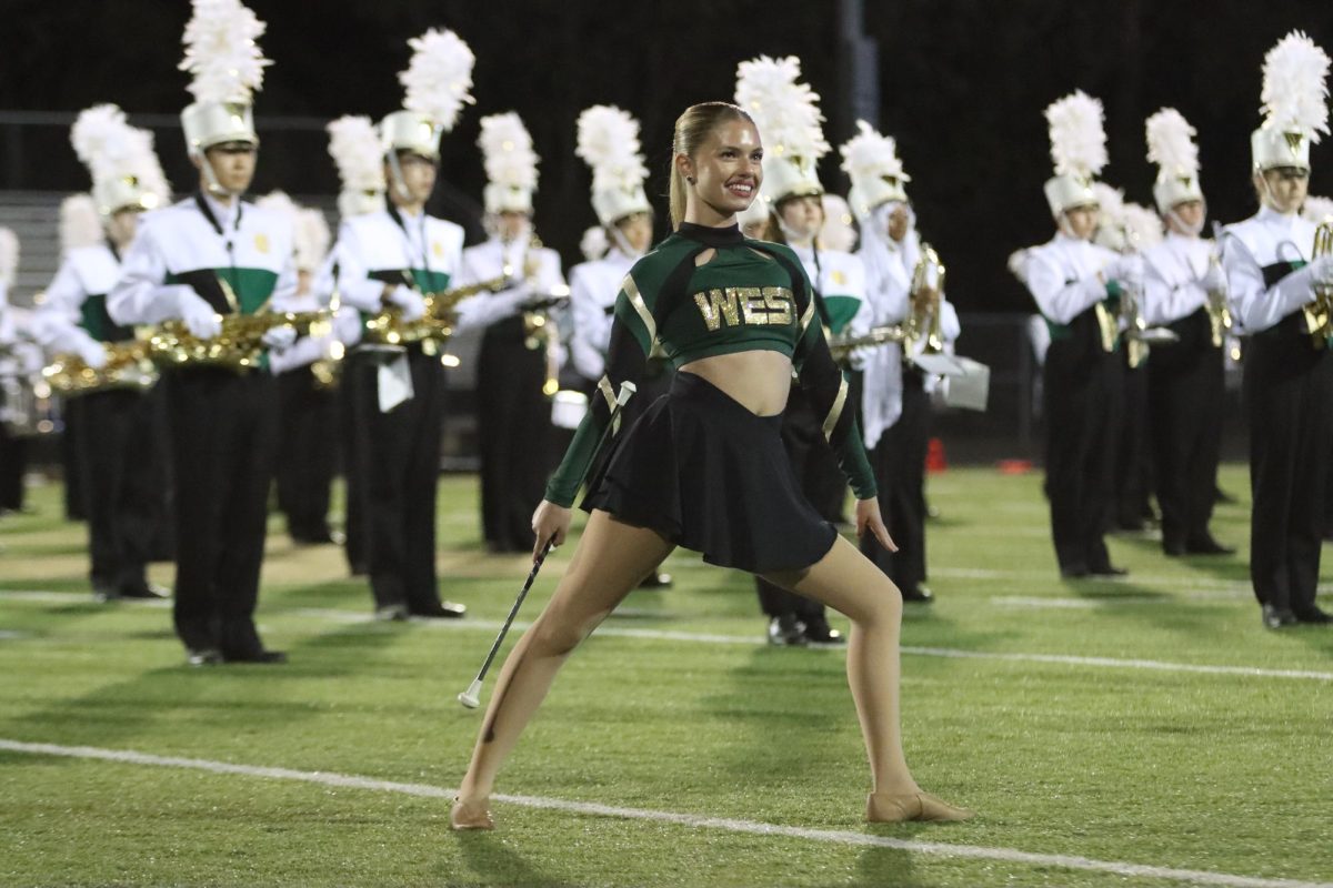 Preparing for her baton routine, Julia Dorale '26 stands at a Trojan football game Sept. 5. 