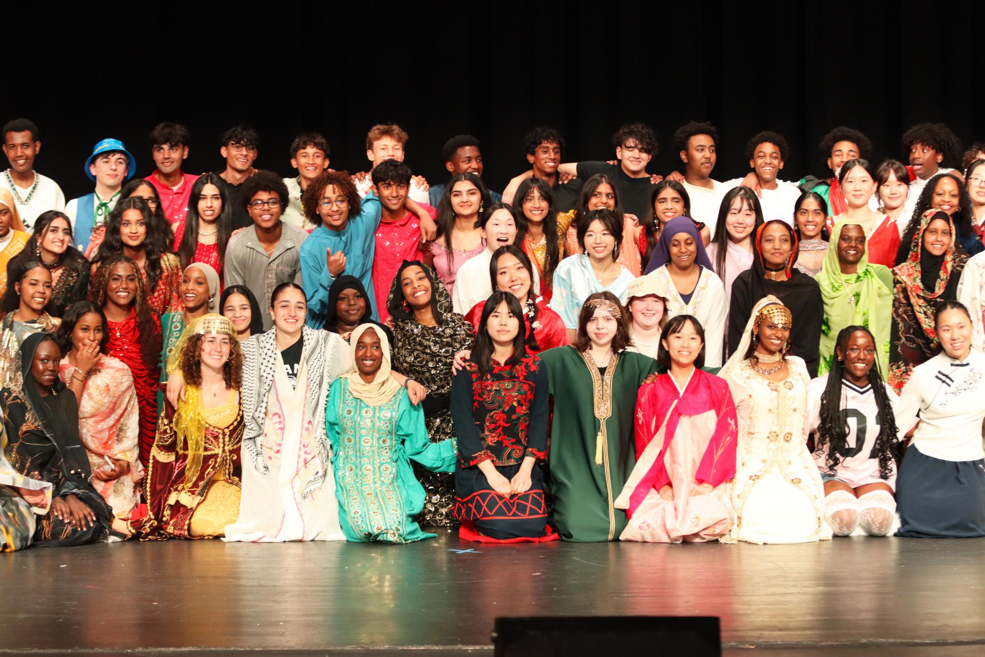 Performers from Walk It Out pose together to end the show May 16. The night was split into five different regions, with fashion shows and dances from each.