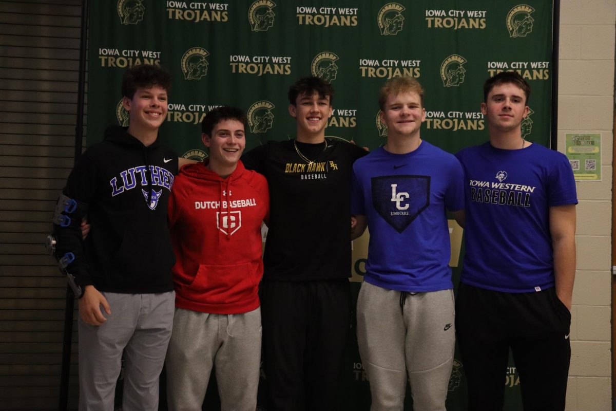 Brady Thoma '26 poses for a picture with his baseball teammates at signing day Feb. 4. 