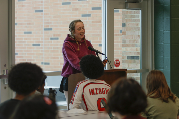 Greta Gromacki ’26 reads her poetry to listeners at the open mic event May 19 in the student commons. Gromacki read multiple poems, including pieces of her own work.