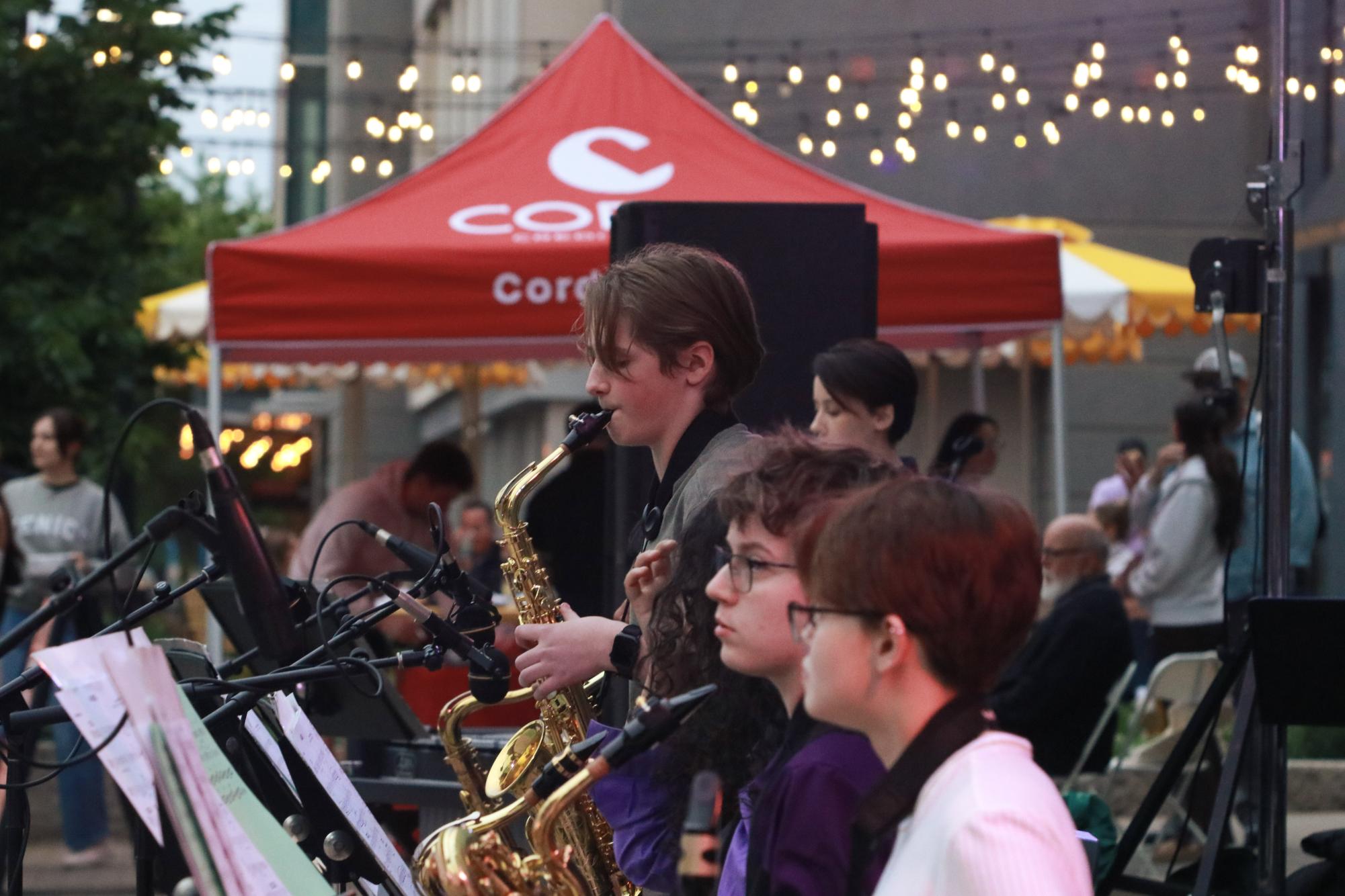 Freshman Isaac Ceynar plays a solo on the saxophone in downtown Iowa City. West High's jazz bands played at the Friday Night Concert Series May 22.